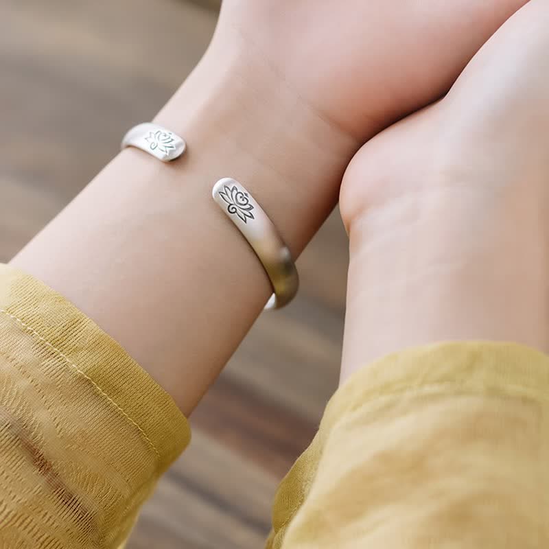 Matching lotus silver bangles held by couple, expressing harmony and spiritual connection by TheFuMaster