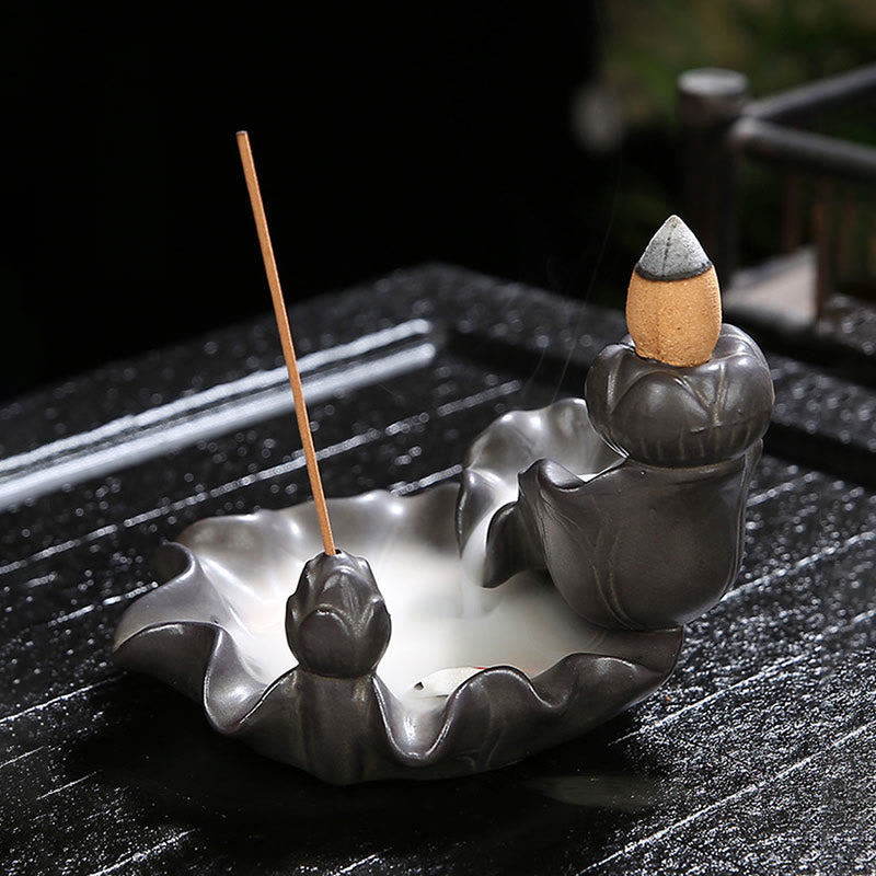 Incense burner with incense sticks on a dark surface