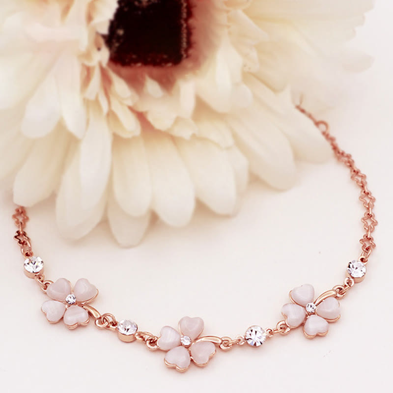 Crafted with rose gold-plated chain featuring three cherry blossom pink cat's eye clover flowers, each accented with sparkling crystal centers and star-shaped links, this bracelet exudes soft romance and symbolizes luck, hope, and love—perfect for gifting or personal wear.
