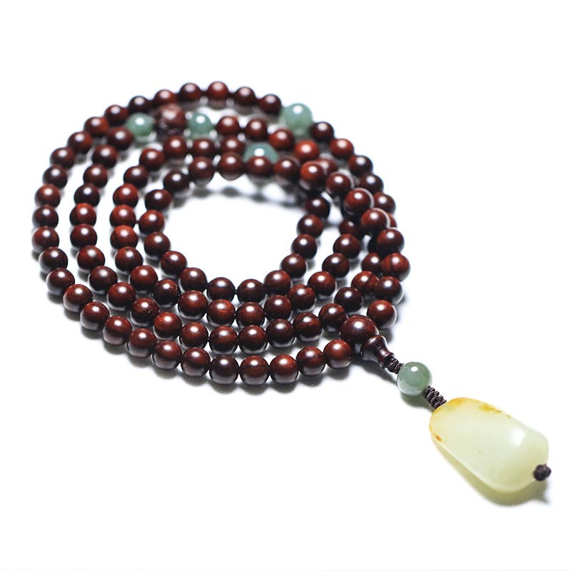Wooden beaded necklace with a jade pendant on a white background