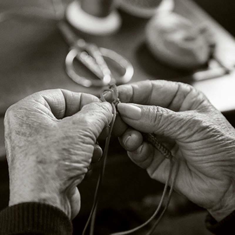 Artisan weaving the Five-Color Longevity Blessing Bracelet – traditional handcraft of Eastern blessing culture.