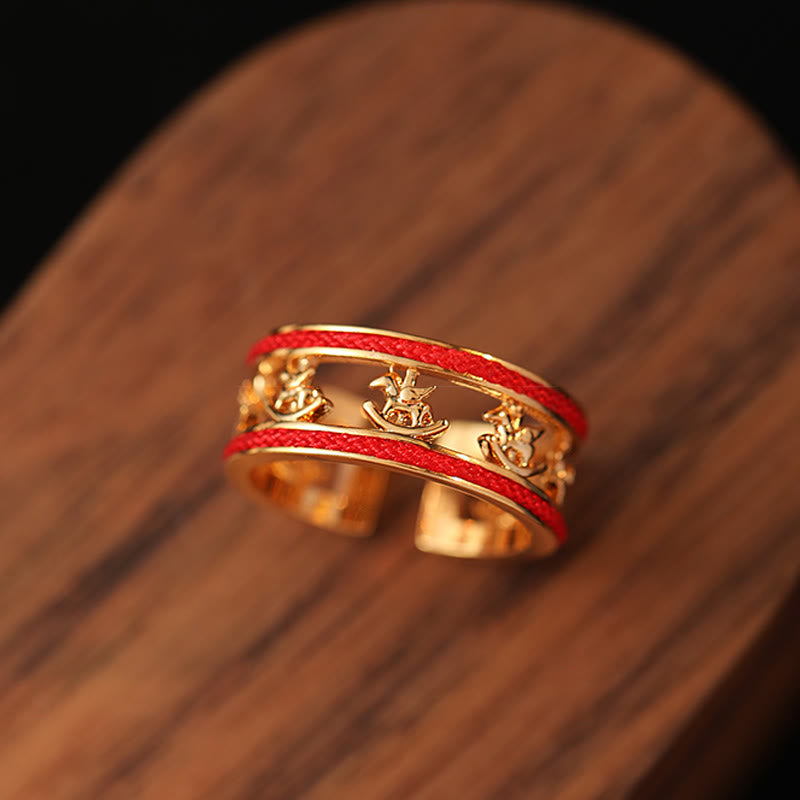 Band detail of Guarded Fortune Horse Year Statement Ring with red and gold styling