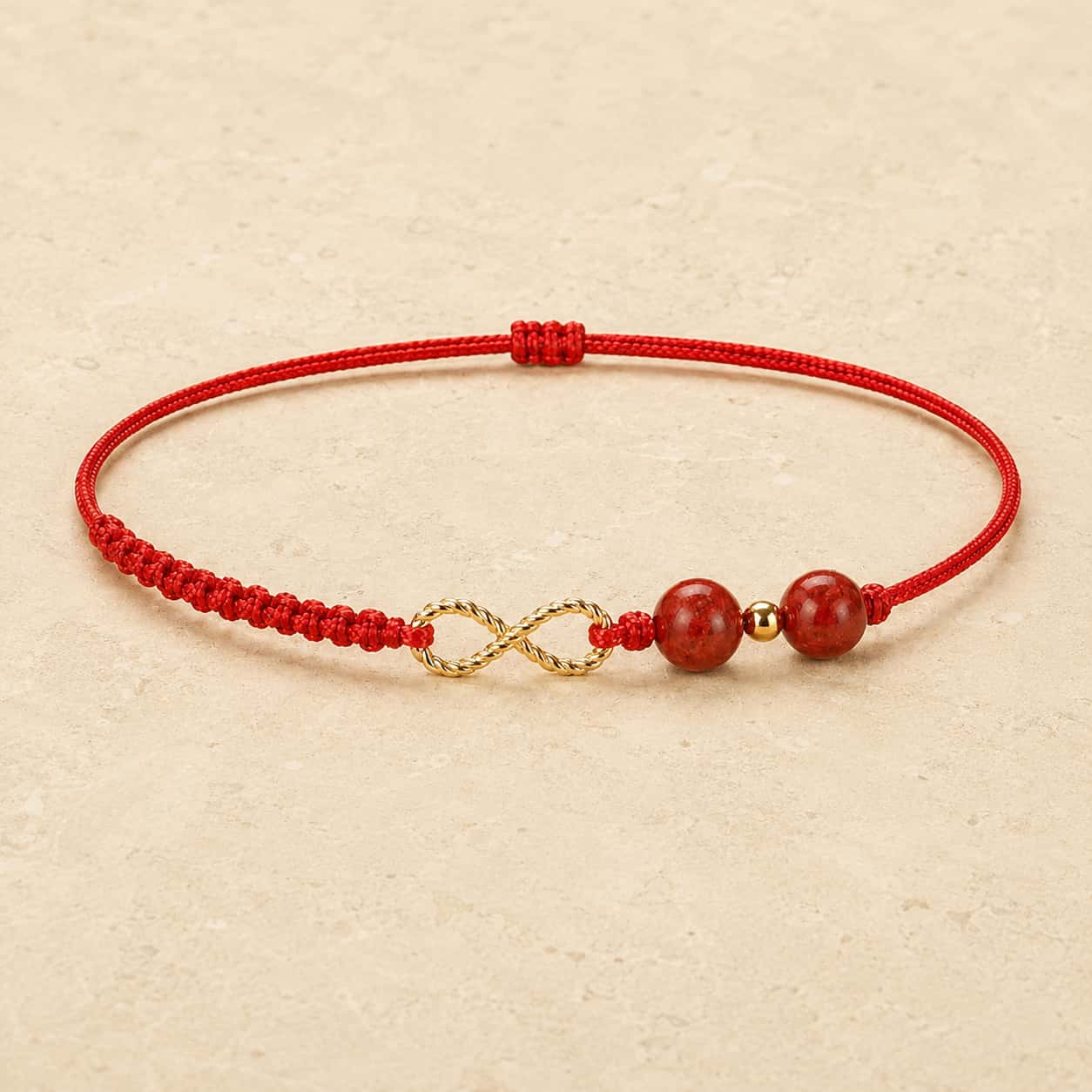 Infinity Red String Bracelet detail view with red string and cinnabar