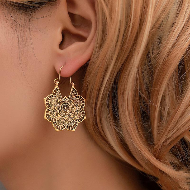 Model wearing TheFuMaster Lotus Engraving Copper Drop Earrings symbolizing balance and blessing