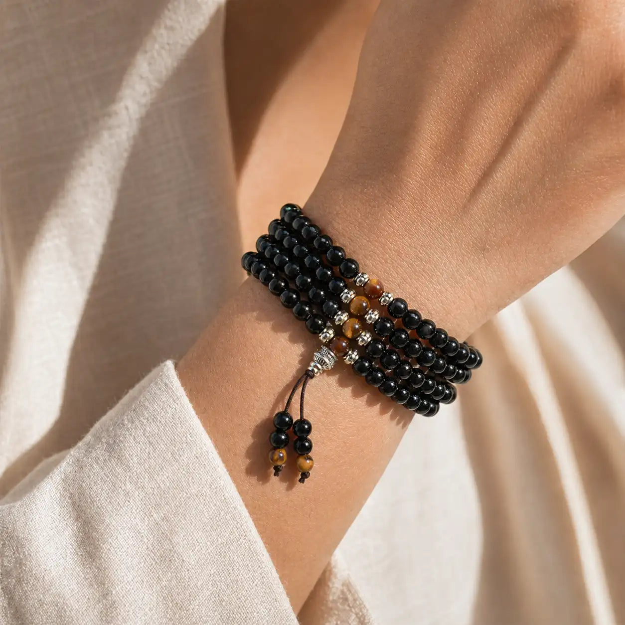 Black Obsidian and Tiger’s Eye Blessing Mala Bracelet worn on the wrist for protection and strength