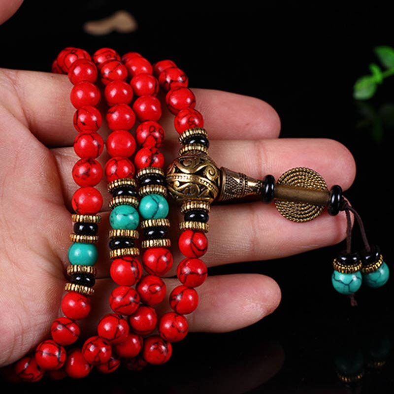 Hand holding red turquoise mala beads for meditation – TheFuMaster