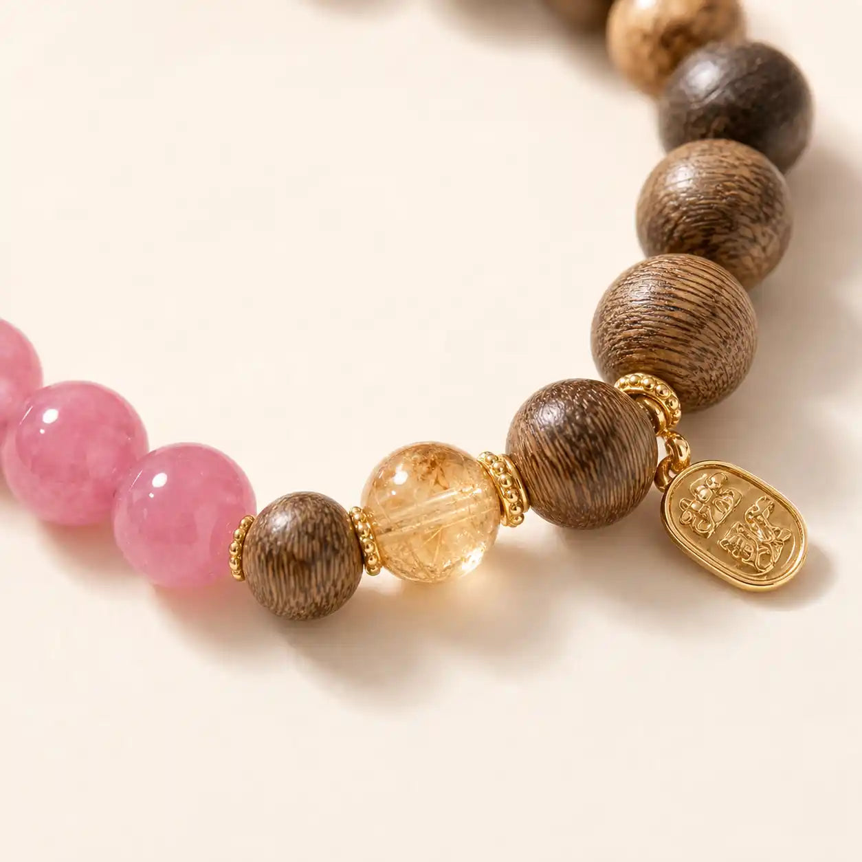 Rose Quartz Wood Lotus Bracelet shown from another angle with clear quartz and rose quartz