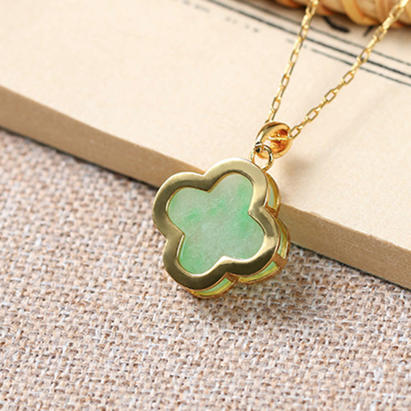 Side angle view of Serene Clover Jade Pendant Necklace with smooth jade texture and gold edge