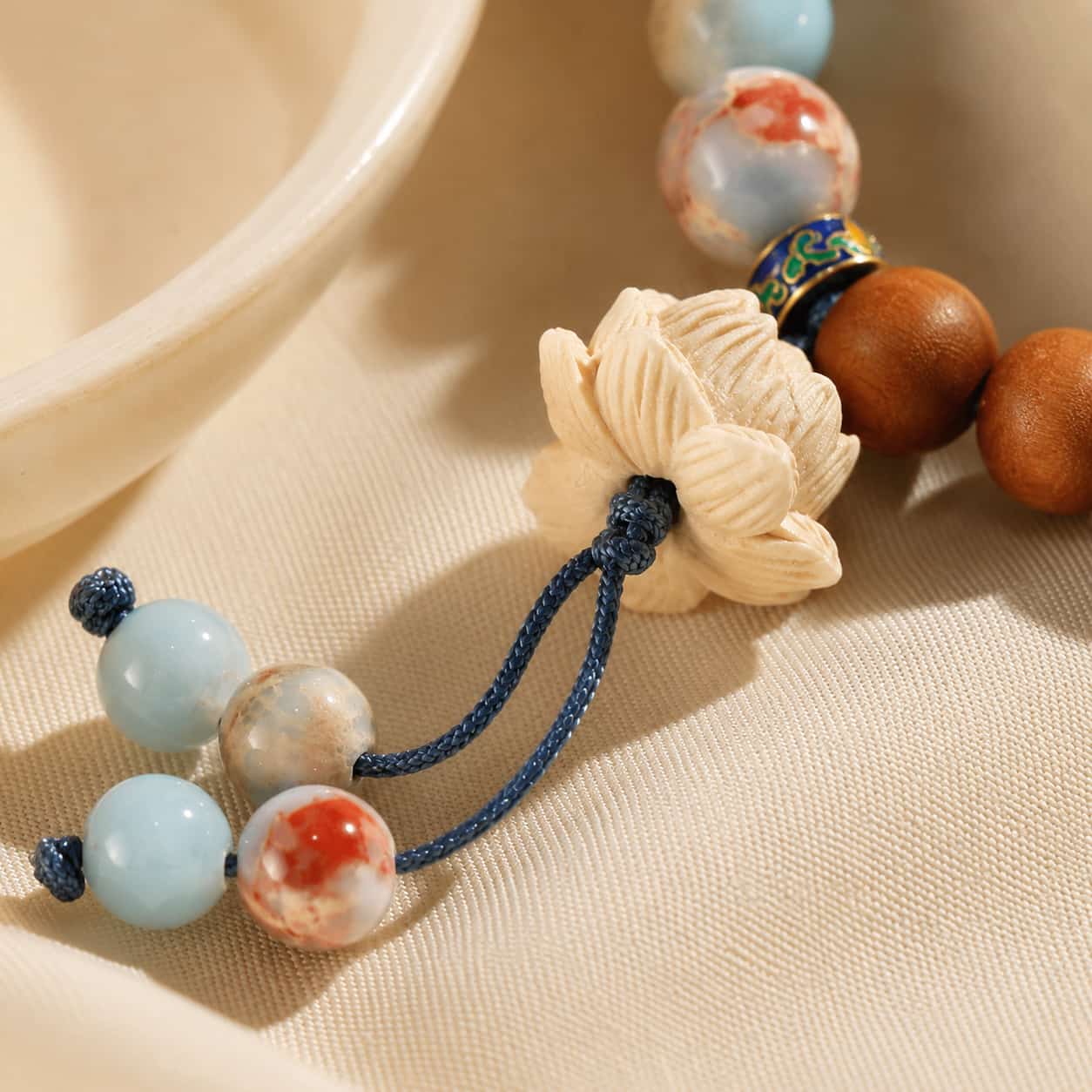Shoushan Stone & Golden Sandalwood Lotus Bracelet shown from another angle with sandalwood and lotus