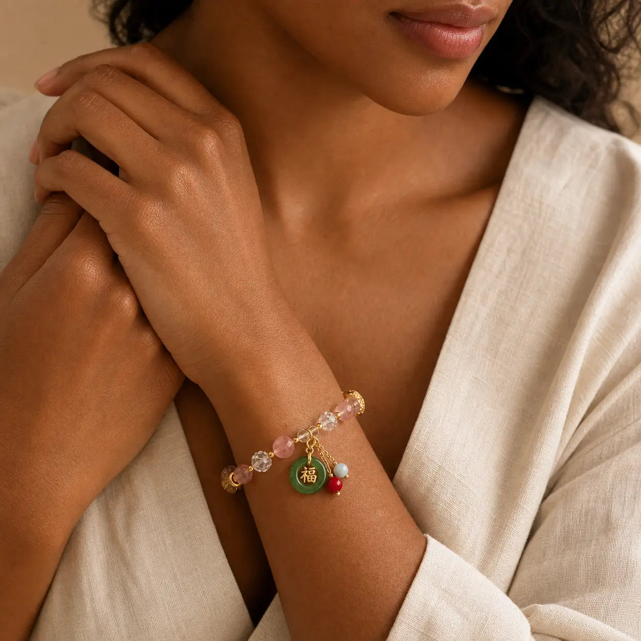 Strawberry Quartz and Jade Fu Charm Bracelet worn on wrist with colorful charms