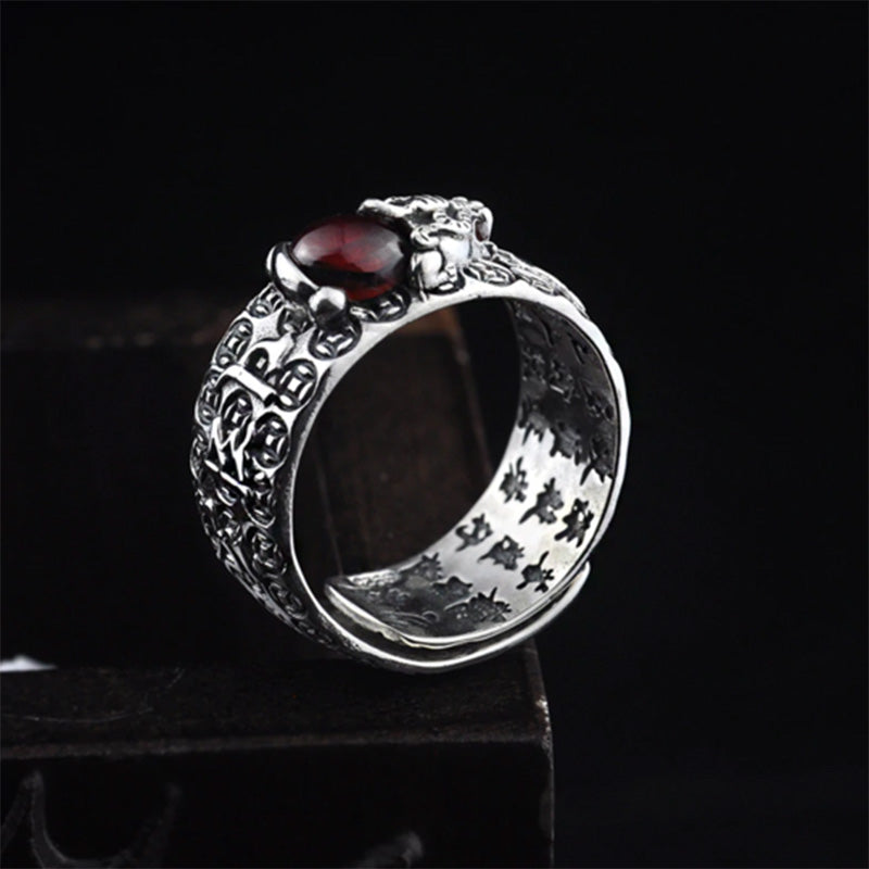 Detailed view of PiXiu engraving and inner Buddhist mantra on the Garnet Wealth Ring