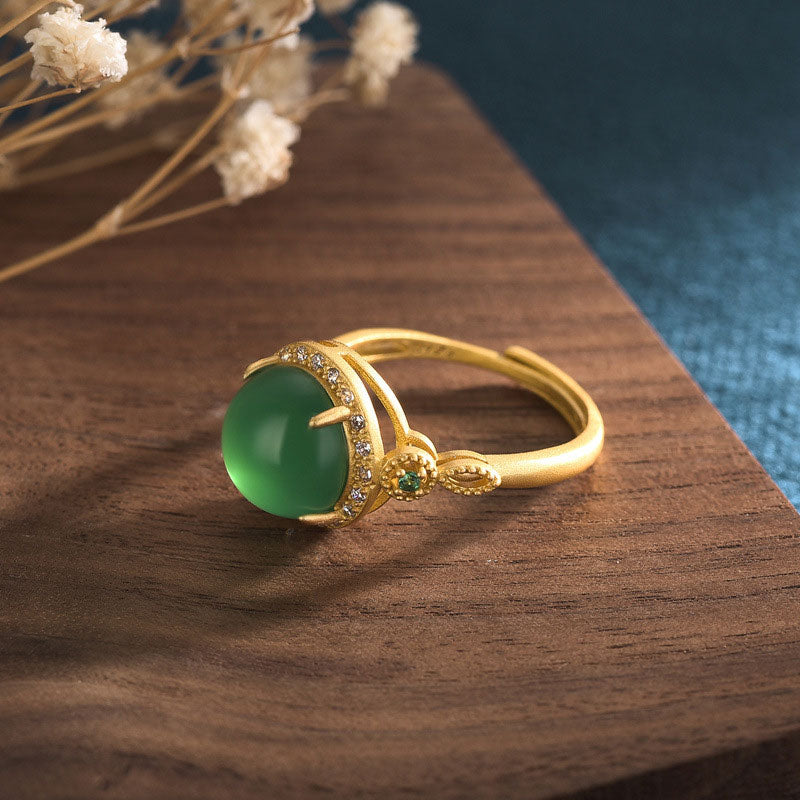 Side angle of Green Jade Fortune Ring showing gold plated band and gem details