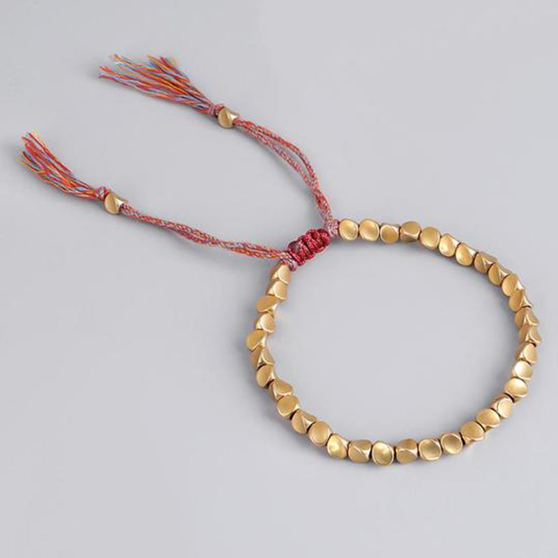 Full top view of Tibetan Copper Luck Bracelet with braided red cord, minimalist design for everyday wear.