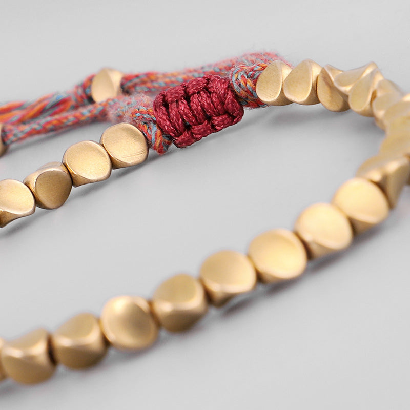 Twin red-thread version of the Tibetan Copper Bracelet, handmade with balanced symmetry.