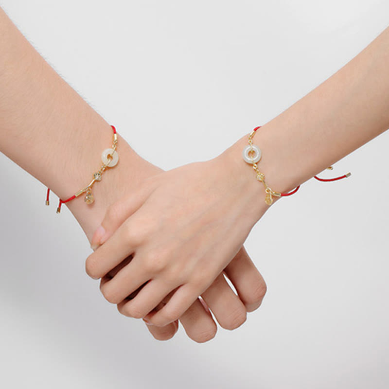 Close-up of TheFuMaster red rope jade Peace Bracelet worn on wrist, showing subtle gold details