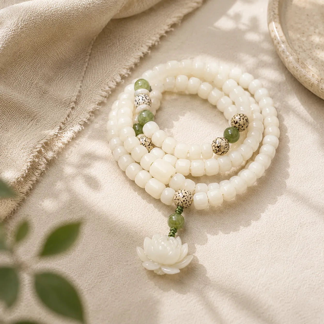White Bodhi Lotus Mala detail view with bodhi and lotus