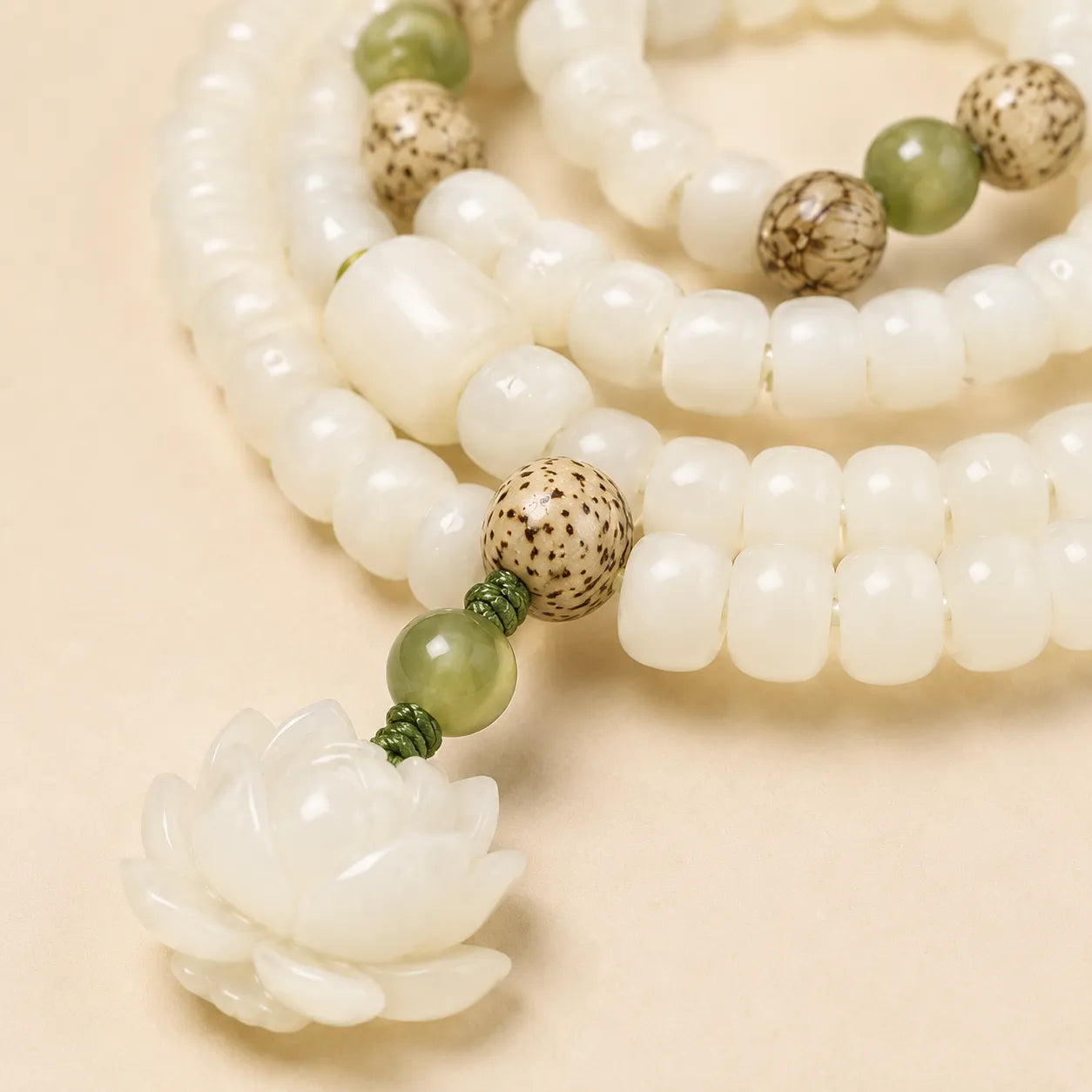 White Bodhi Lotus Mala shown from another angle with bodhi and lotus