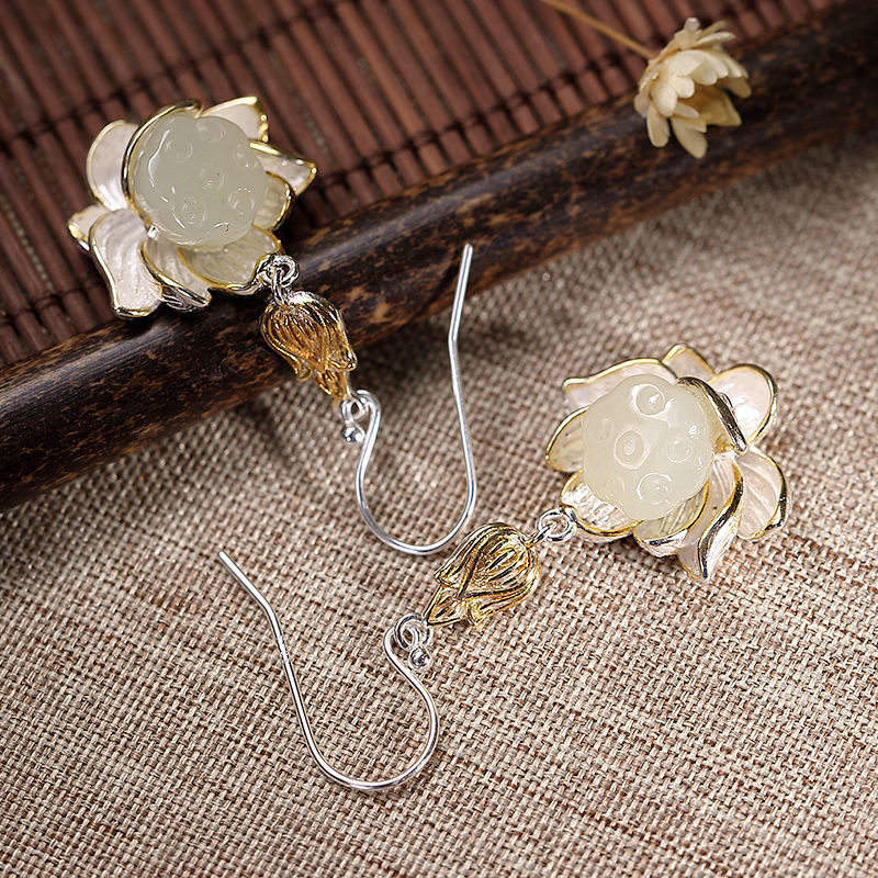Flatlay of White Jade Lotus Earrings with sterling silver hooks showing detailed lotus petals design