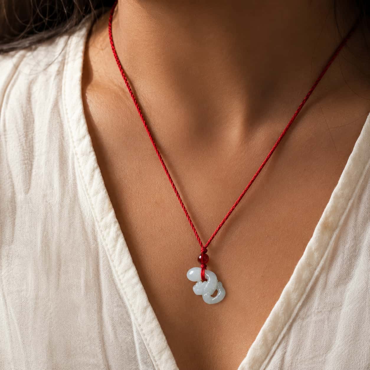 Close-up of White Jade Snake Zodiac Pendant with white jade