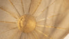 Warm summer solstice light through a paper parasol for seasonal intention