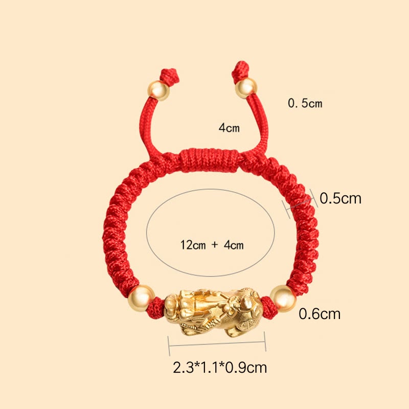 Red bracelet with gold accents and measurements on a beige background
