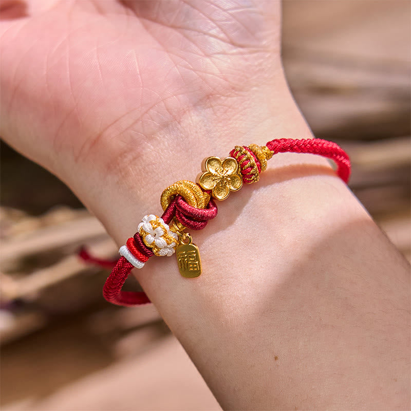 Handwoven with red cord, adorned with a golden peach blossom and a "Fu" (blessing) pendant, symbolizing love and good fortune. The exquisite design blends traditional auspicious meaning with modern style, making it a perfect accessory for daily wear.