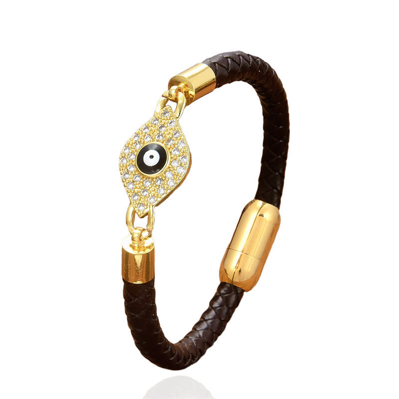 Bracelet with gold evil eye charm on a white background