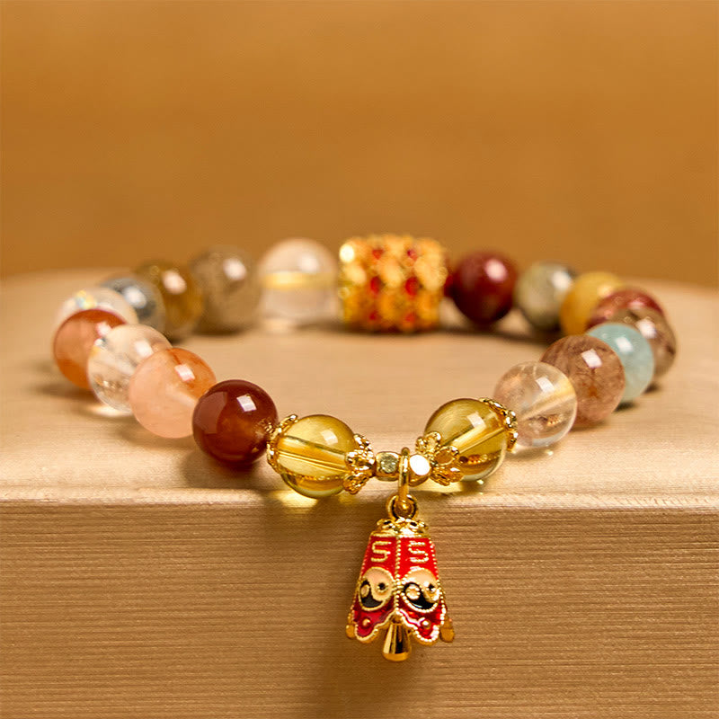 Multicolored beaded bracelet with a gold charm on a wooden surface