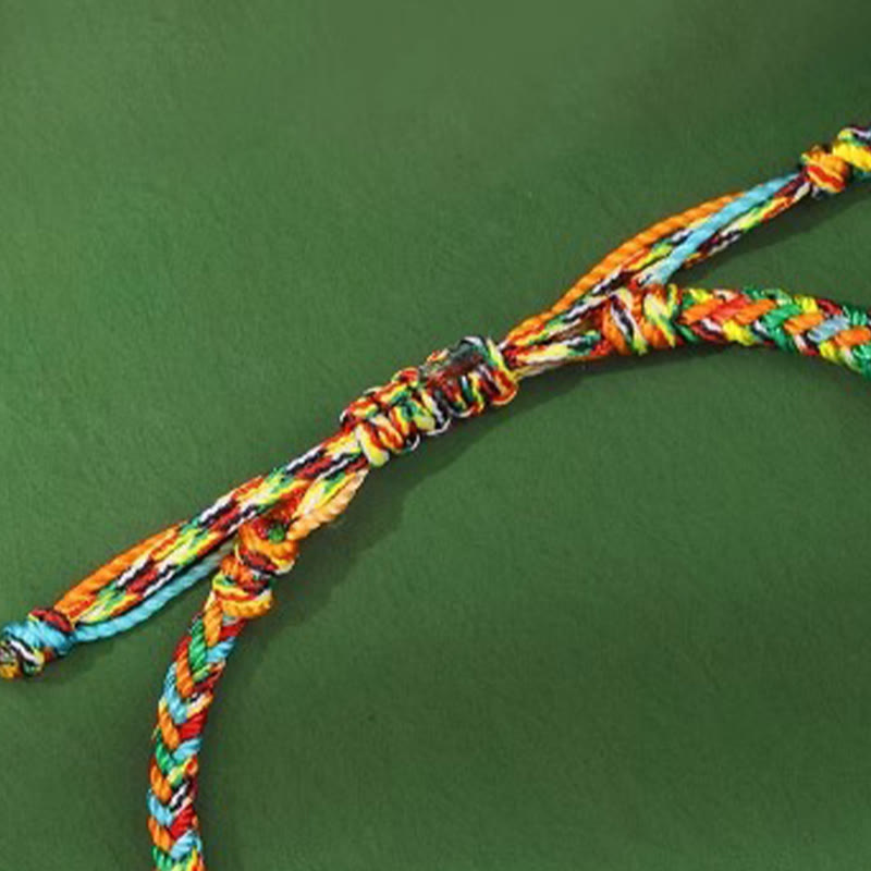 Colorful braided bracelet on a green background