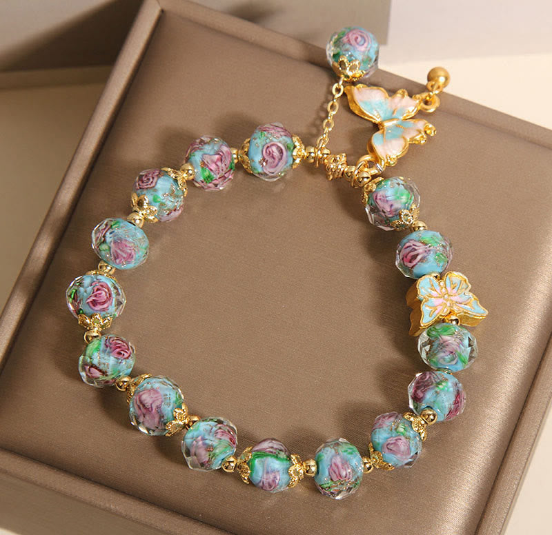 Colorful beaded bracelet with gold accents on a beige surface