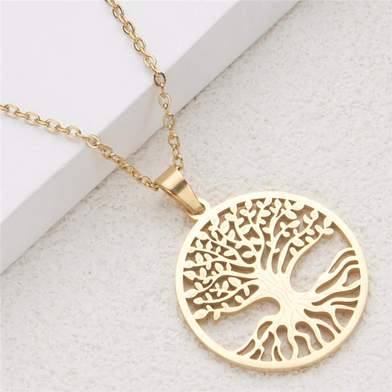 Gold tree of life necklace on a light background