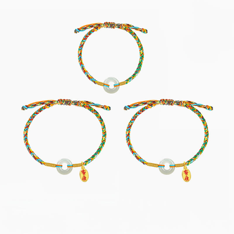 Three colorful bracelets with charms on a white background