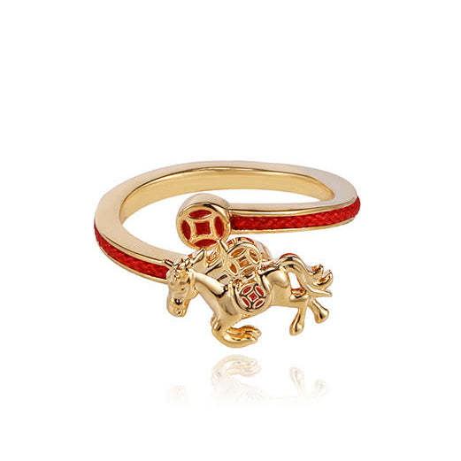Gold ring with a horse charm on a white background