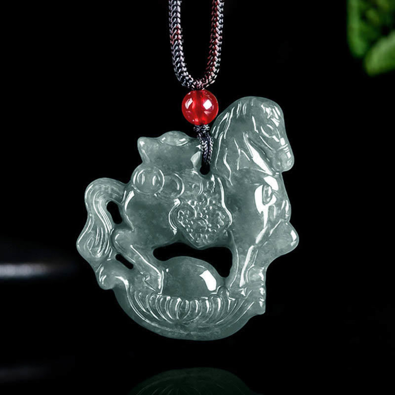 Green jade horse pendant with a red bead on a black background