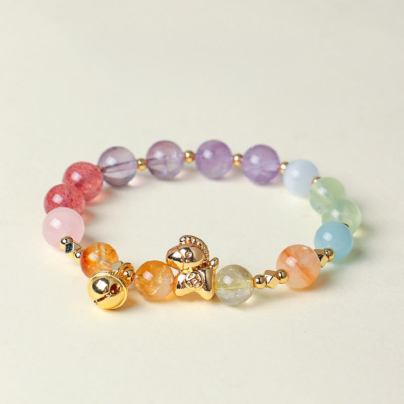 Multicolored beaded bracelet with gold accents on a light background