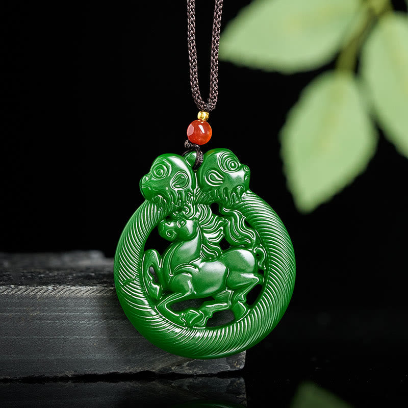 Green jade pendant with intricate design on a dark background