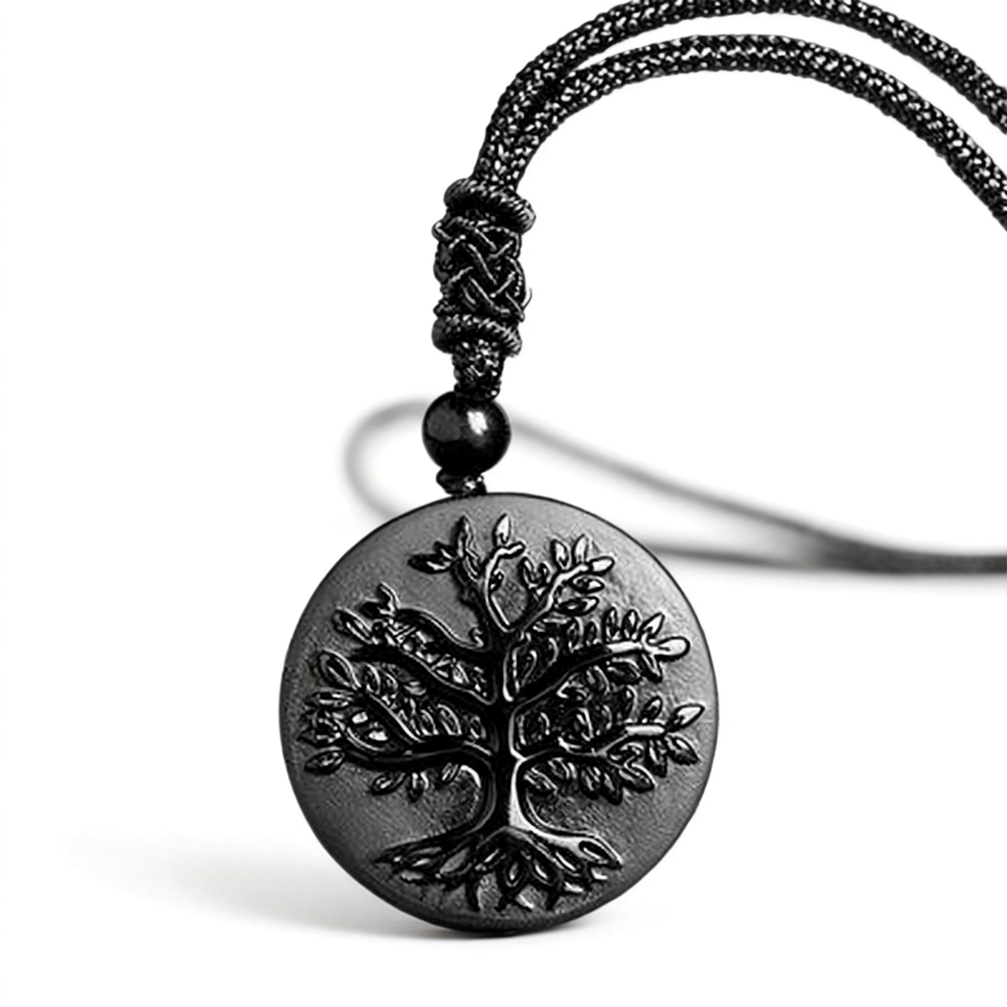 Black tree-of-life pendant on a black cord against a white background