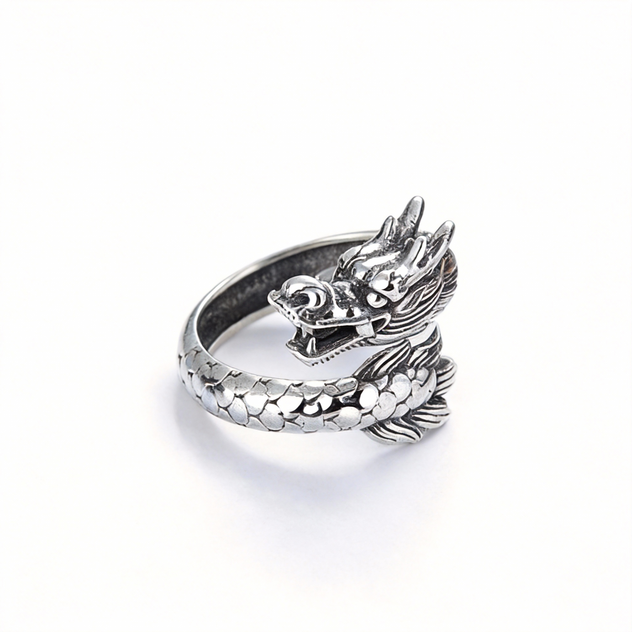 Silver dragon-shaped ring on a white background