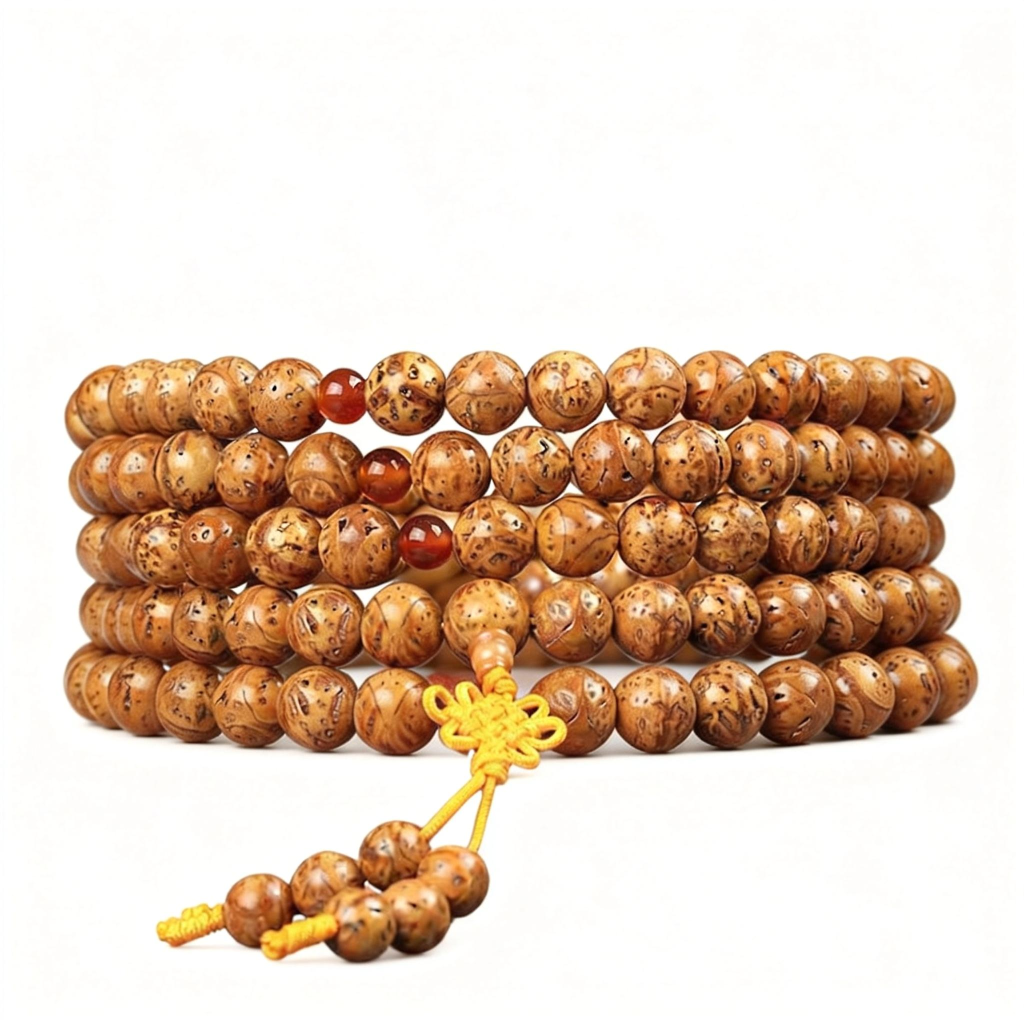 Stack of wooden prayer beads with a yellow string on a white background