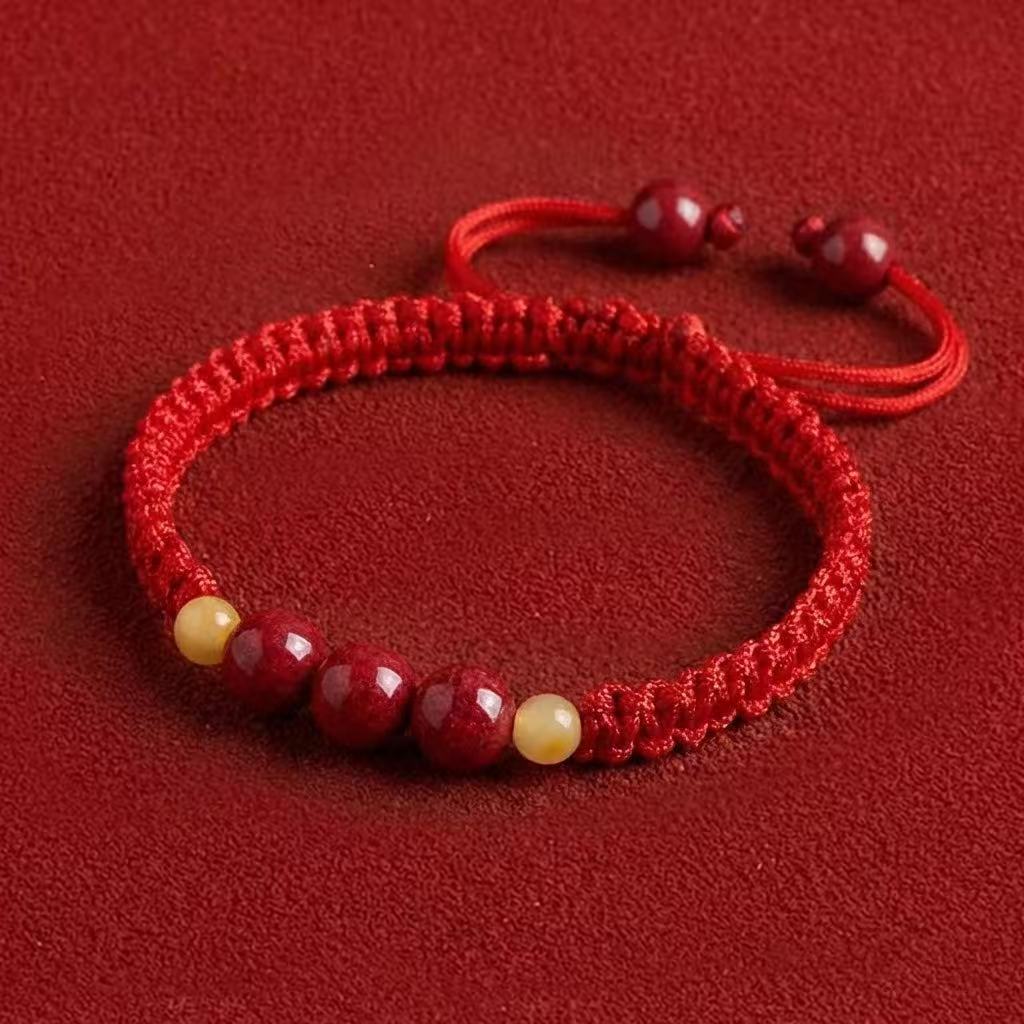 Red bracelet with beads on a red background