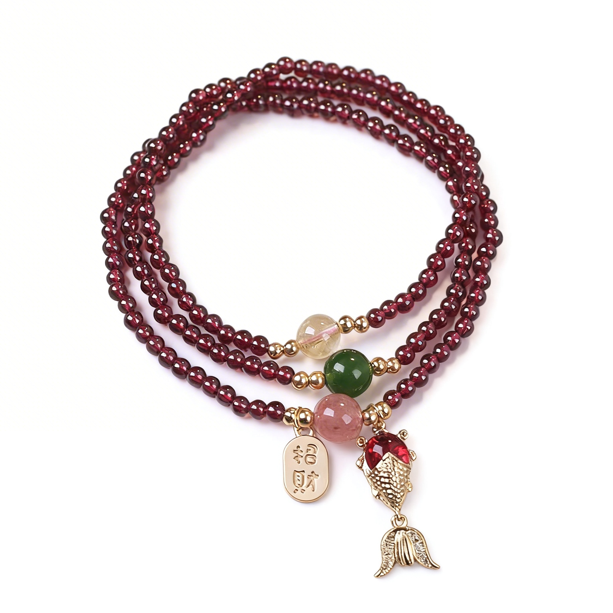 Multistrand beaded bracelet with various charms on a white background