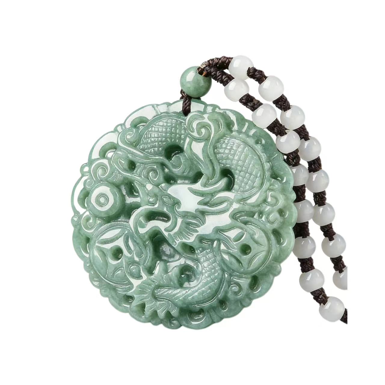 Decorative jade pendant with intricate designs on a white background