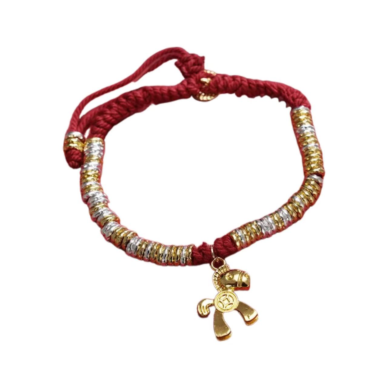 Bracelet with red cord, gold and silver beads, and a gold charm on a white background