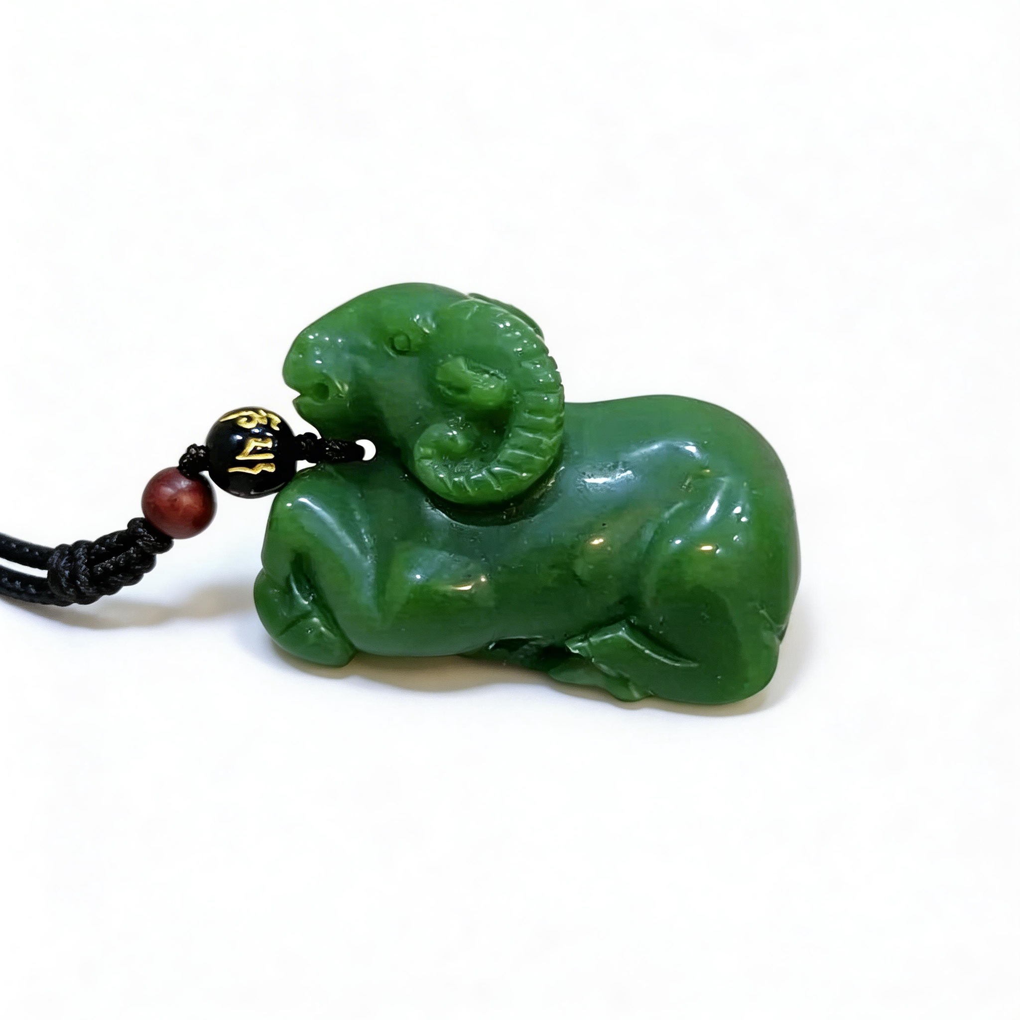 Green ram-shaped pendant on a white background