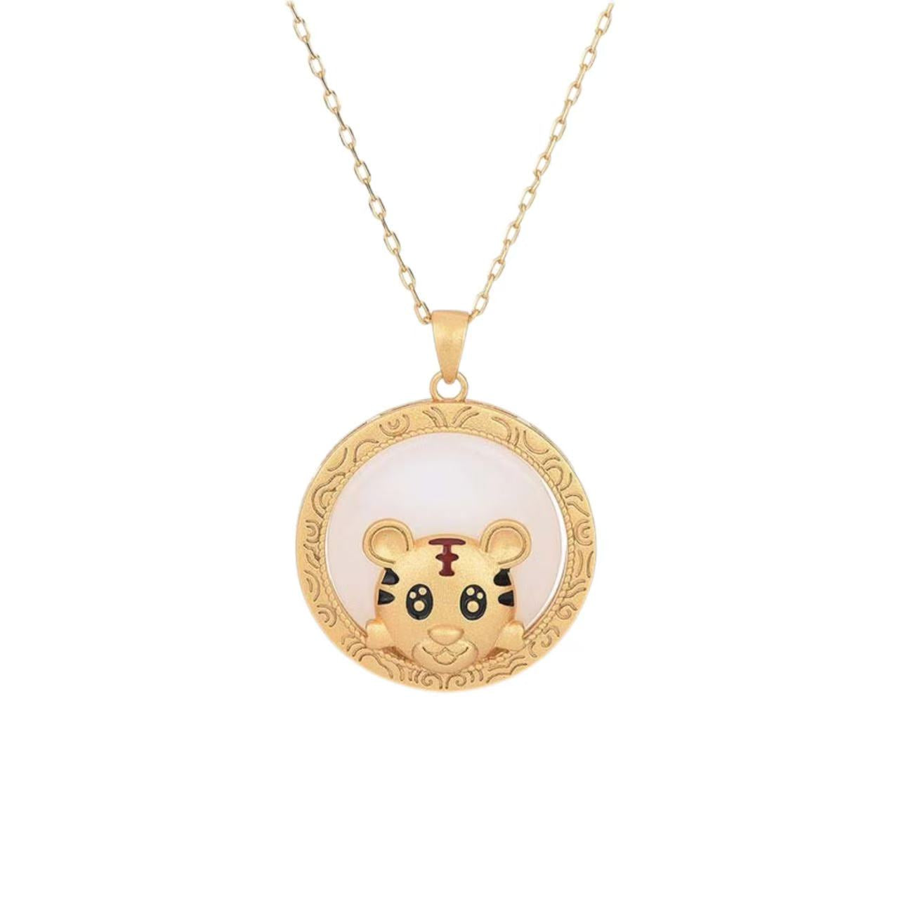 Gold necklace with a round pendant featuring a tiger design on a white background