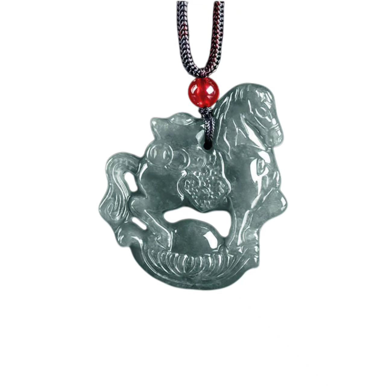 Green jade pendant with horse design on a red bead necklace against a white background