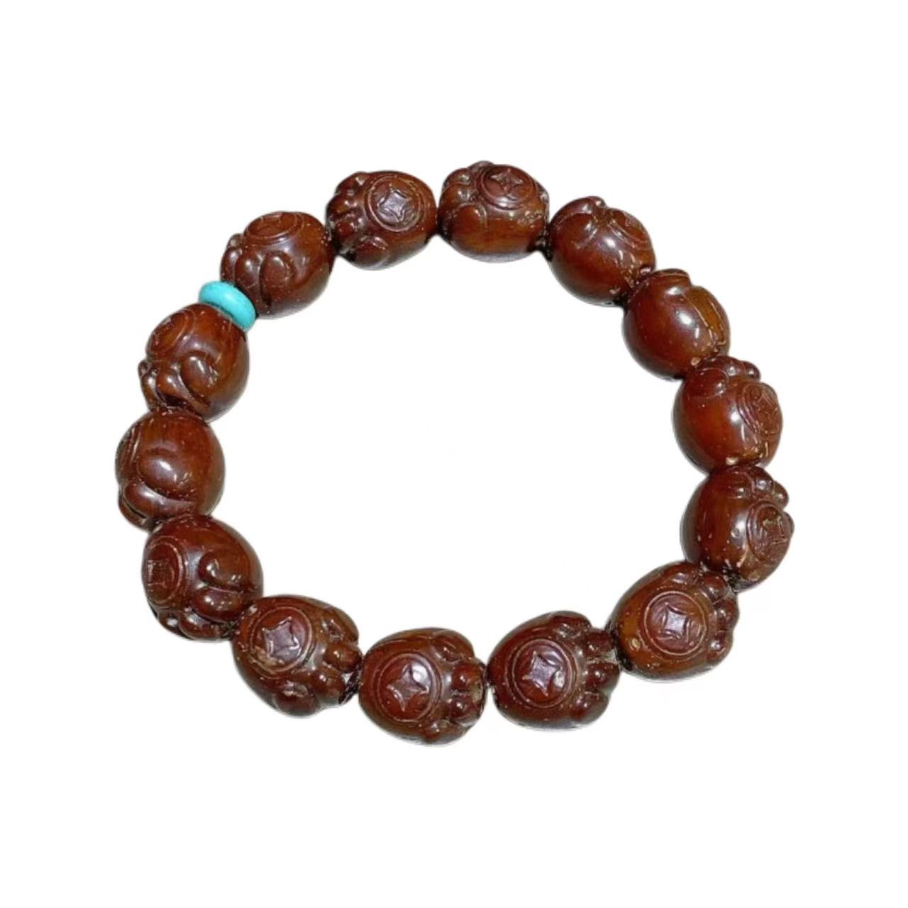 Brown beaded bracelet with a turquoise accent on a white background