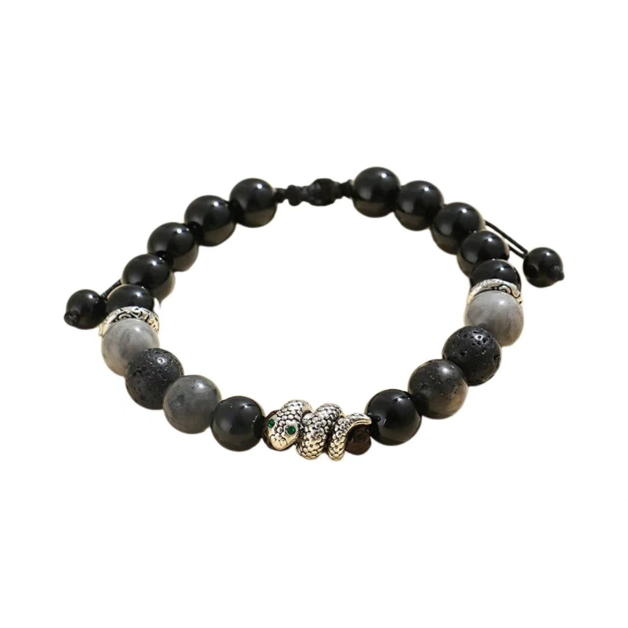 Black beaded bracelet with silver and gold accents on a white background