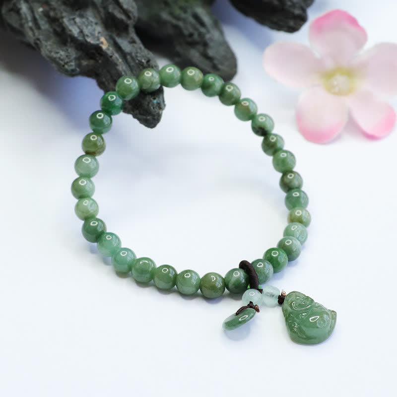Green beaded bracelet with a pendant on a white background
