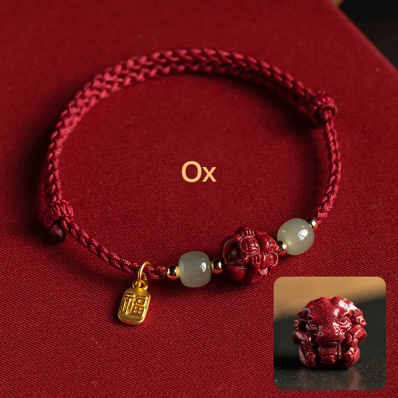 Red braided bracelet with decorative beads and charms on a red background